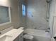 Bathroom features a bathtub, shower, and marble-style tile surround at 4710 Bloom Dr, Plant City, FL 33566