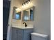 Modern bathroom with gray vanity, quartz countertop, and mirrors at 4710 Bloom Dr, Plant City, FL 33566