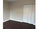 Simple bedroom with dark laminate floors and a large closet at 4710 Bloom Dr, Plant City, FL 33566