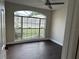 Bright bedroom with laminate wood flooring and large window at 4710 Bloom Dr, Plant City, FL 33566