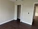 Bright bedroom with dark laminate flooring and double door closet at 4710 Bloom Dr, Plant City, FL 33566