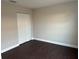 Spacious bedroom with dark laminate flooring and double door closet at 4710 Bloom Dr, Plant City, FL 33566