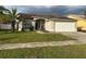 Single-story home with attached garage and well-manicured lawn at 4710 Bloom Dr, Plant City, FL 33566