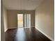 Living room with dark laminate wood flooring and sliding glass doors at 4710 Bloom Dr, Plant City, FL 33566