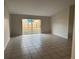 Spacious living room with tile flooring and sliding glass doors to the patio at 4710 Bloom Dr, Plant City, FL 33566