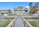 Private backyard with a walkway leading to the dock and offering serene water views at 7899 Causeway N Blvd, St Petersburg, FL 33707