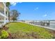 Landscaped backyard with grassy lawn and access to a private dock at 7899 Causeway N Blvd, St Petersburg, FL 33707