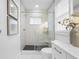 Clean bathroom with a walk-in shower, white cabinets, and modern fixtures at 7899 Causeway N Blvd, St Petersburg, FL 33707