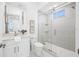 Modern bathroom with white vanity, toilet and a patterned shower at 7899 Causeway N Blvd, St Petersburg, FL 33707