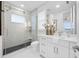 Modern bathroom with a walk-in shower, white cabinets, and a quartz countertop at 7899 Causeway N Blvd, St Petersburg, FL 33707