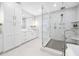 Modern bathroom with white cabinets, a glass shower, and patterned tile at 7899 Causeway N Blvd, St Petersburg, FL 33707