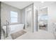 Elegant bathroom with a free-standing tub and a view of the bedroom at 7899 Causeway N Blvd, St Petersburg, FL 33707