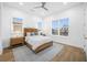 Bright bedroom with wood bed, light wood floors and large windows at 7899 Causeway N Blvd, St Petersburg, FL 33707