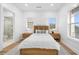 Charming bedroom with wood bed, light wood floors and en-suite bathroom at 7899 Causeway N Blvd, St Petersburg, FL 33707