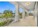 Spacious covered porch with tile flooring and metal railings, offering scenic views at 7899 Causeway N Blvd, St Petersburg, FL 33707