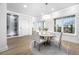 Modern dining room features a round table with white chairs and an adjacent wine cellar at 7899 Causeway N Blvd, St Petersburg, FL 33707