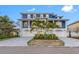 Stunning waterfront home boasts a two-story design, three-car garage, and a beautiful paver driveway at 7899 Causeway N Blvd, St Petersburg, FL 33707