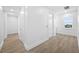 Light hallway with hardwood floors and white walls at 7899 Causeway N Blvd, St Petersburg, FL 33707