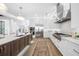 White kitchen with stainless steel appliances and hardwood floors at 7899 Causeway N Blvd, St Petersburg, FL 33707