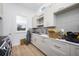 Bright laundry room with gray cabinets and a utility sink at 7899 Causeway N Blvd, St Petersburg, FL 33707