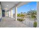 Covered side porch with tile flooring and metal railings, offering street views at 7899 Causeway N Blvd, St Petersburg, FL 33707