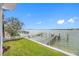 Expansive view of the water from the backyard, featuring a private dock and lush landscaping at 7899 Causeway N Blvd, St Petersburg, FL 33707