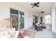 Relaxing screened-in porch with comfortable seating and ceiling fans, ideal for outdoor enjoyment at 14818 Grady Sweat Ln, Wimauma, FL 33598