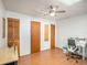 Bright bedroom with wood floors, ceiling fan, and built-in shelving at 250 Rosery Nw Rd # 260, Largo, FL 33770