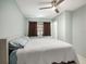 King-size bed in a well lit bedroom with ceiling fan at 250 Rosery Nw Rd # 260, Largo, FL 33770