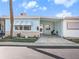 Front view of a light blue house with carport at 250 Rosery Nw Rd # 260, Largo, FL 33770