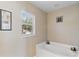 Bright bathroom features a large soaking tub and a window for natural light at 19245 Wood Sage Dr, Tampa, FL 33647