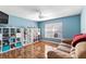 Bright bedroom featuring hardwood floors, a ceiling fan, and built-in shelving for ample storage at 19245 Wood Sage Dr, Tampa, FL 33647