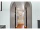 Unique hallway with arched entryways on both sides leading to closets and other rooms at 19245 Wood Sage Dr, Tampa, FL 33647