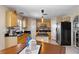 Bright kitchen featuring stainless steel appliances, a central island, and ample cabinet space at 19245 Wood Sage Dr, Tampa, FL 33647