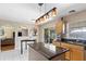 Kitchen with a view to the patio, center island, black countertop, and bright cabinets at 19245 Wood Sage Dr, Tampa, FL 33647