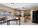 Inviting kitchen with stainless steel appliances, a central island, and a sliding glass door to the screened patio at 19245 Wood Sage Dr, Tampa, FL 33647