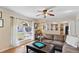 Cozy living room featuring a large window, archways, neutral paint, and a ceiling fan at 19245 Wood Sage Dr, Tampa, FL 33647