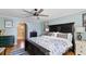 Spacious primary bedroom showcasing a dark wood bed frame, hardwood floors, and light blue walls at 19245 Wood Sage Dr, Tampa, FL 33647