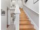 Staircase with wood treads, white risers, and a decorative ledge at the landing at 19245 Wood Sage Dr, Tampa, FL 33647