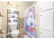 Bathroom with shower, toilet and shelving unit at 1944 Sparkman Rd, Plant City, FL 33566