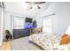 Bedroom with a dresser, fish tank, and ceiling fan at 1944 Sparkman Rd, Plant City, FL 33566