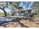 Gray house with a deck, surrounded by trees at 1944 Sparkman Rd, Plant City, FL 33566