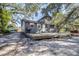 Gray house with a deck, surrounded by trees at 1944 Sparkman Rd, Plant City, FL 33566