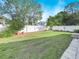 Large backyard with grassy area and white fence at 4512 Preston Woods Dr, Valrico, FL 33596