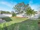 Landscaped backyard with grassy lawn and wooden deck at 4512 Preston Woods Dr, Valrico, FL 33596