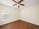 Simple bedroom with wood floors and ceiling fan at 4512 Preston Woods Dr, Valrico, FL 33596