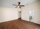 Spacious bedroom with wood-look floors and ceiling fan at 4512 Preston Woods Dr, Valrico, FL 33596