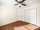 Bedroom with wood floors, ceiling fan, and double doors at 4512 Preston Woods Dr, Valrico, FL 33596