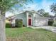 House exterior with red front door and green walls at 4512 Preston Woods Dr, Valrico, FL 33596