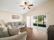 Living room with gray sofas and sliding doors to patio at 4512 Preston Woods Dr, Valrico, FL 33596